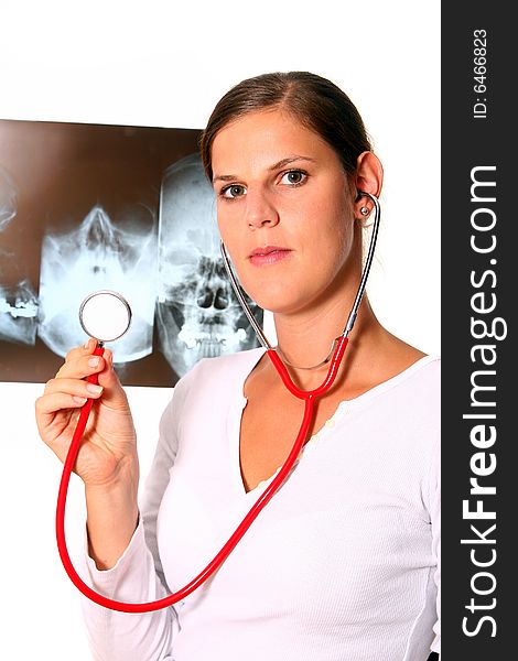 A beautiful young doctor with a red stethoscope and a xray image in the back. Isolated over white. A beautiful young doctor with a red stethoscope and a xray image in the back. Isolated over white.