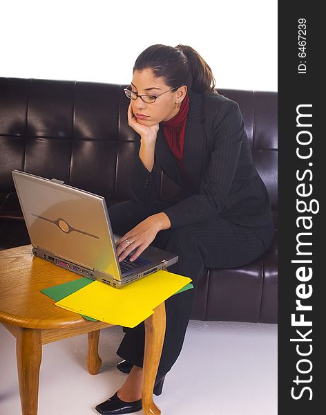 Attractive business woman working, sitting on couch