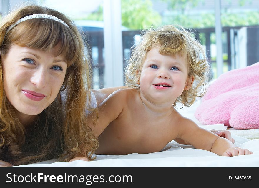 High key portrait of happy mother with baby