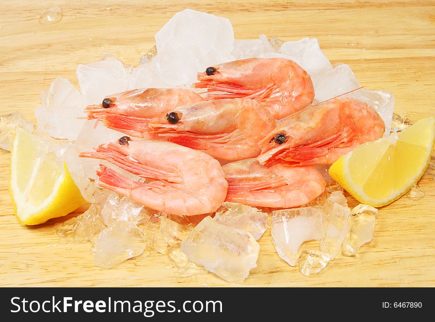 Shell on prawns with lemon on ice. Shell on prawns with lemon on ice