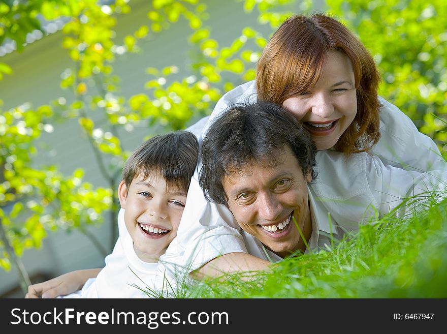 Portrait of young happy family in summer environment. Portrait of young happy family in summer environment