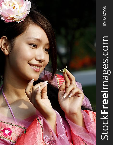 A girl in Chinese ancient dress. she is looking in her hand's butterfly.

In the ancient legend of China, butterfly is a symbol of the beautiful girl. A girl in Chinese ancient dress. she is looking in her hand's butterfly.

In the ancient legend of China, butterfly is a symbol of the beautiful girl.
