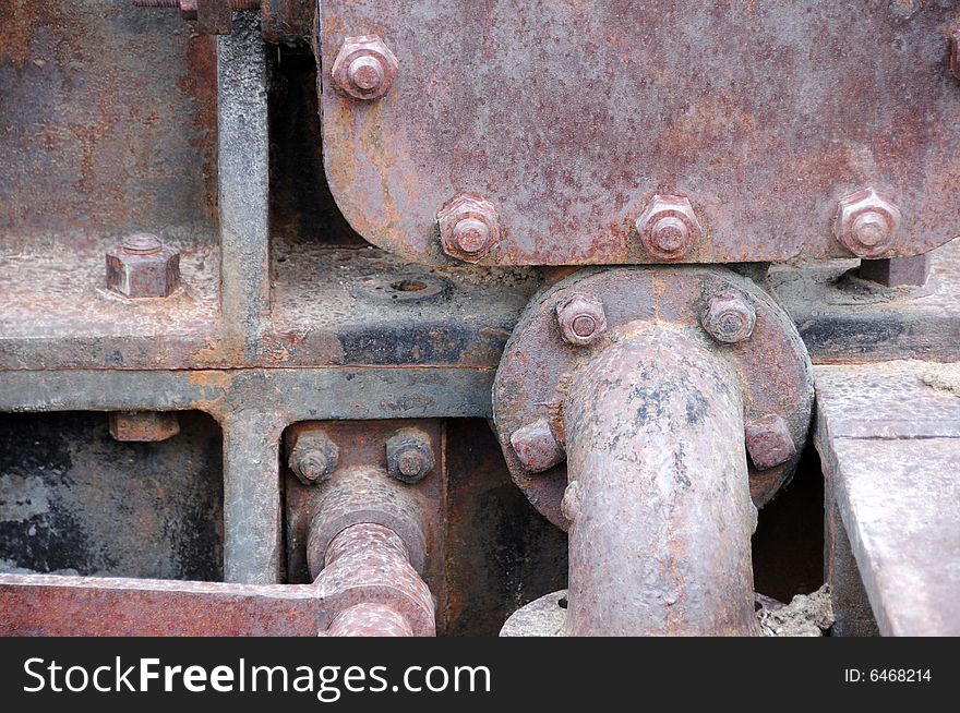 Close up photo of rusty bolts of an old machine