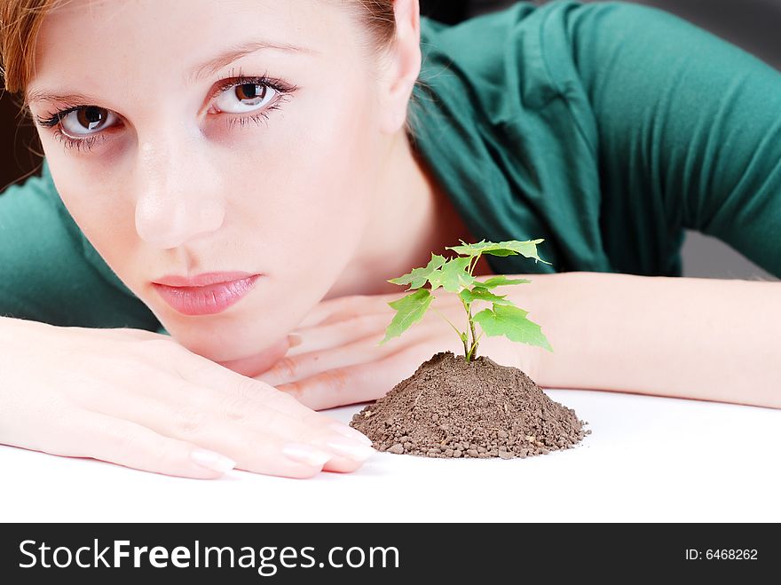 Beautiful young woman with green sprout of tree. Beautiful young woman with green sprout of tree