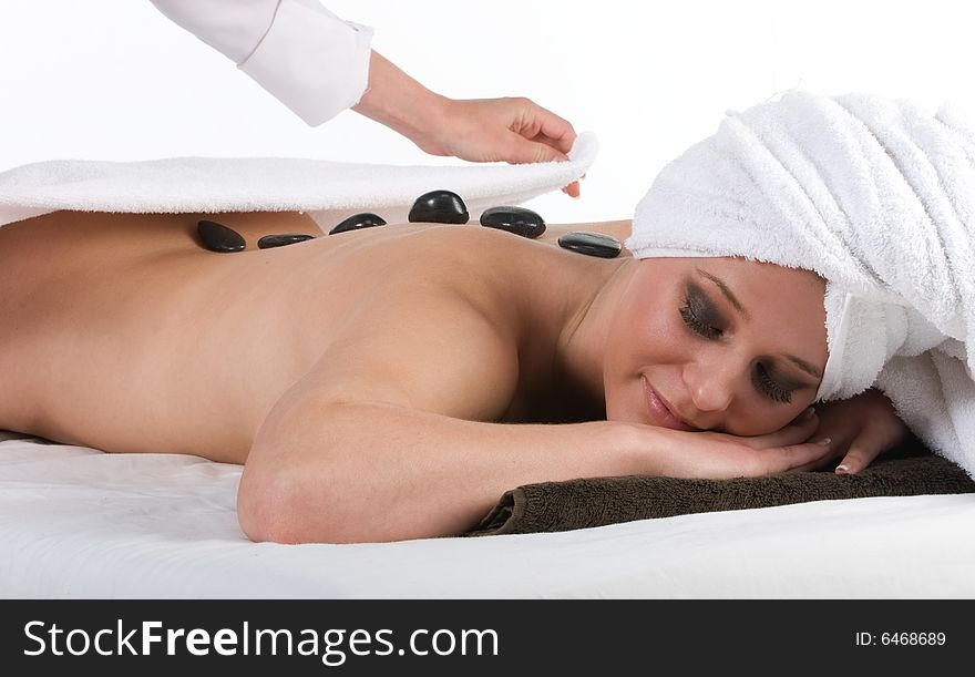 Pretty smiling lady getting hot stone massage