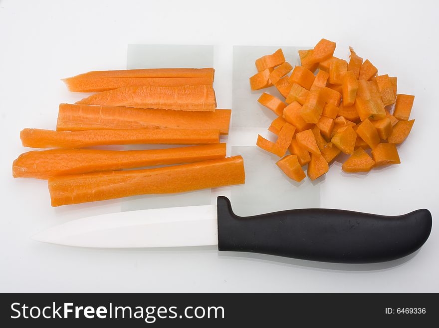 Sliced carrots and a knife on a chopping board