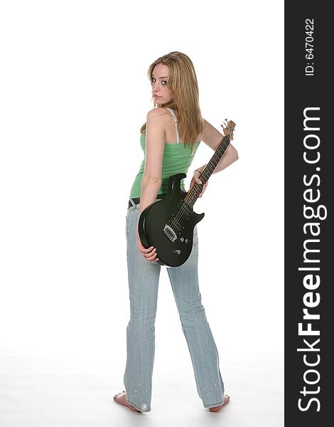 Sexy woman in tight jeans with black guitar