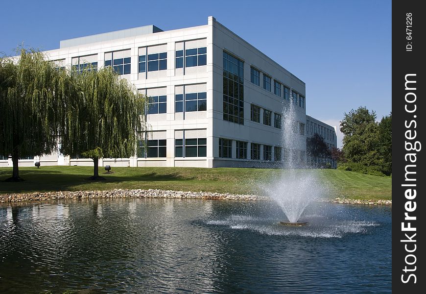 A modern office building with a pond and fountain