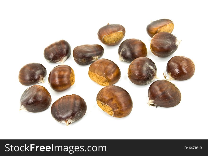 Many ripe chestnuts - isolated on white background.
