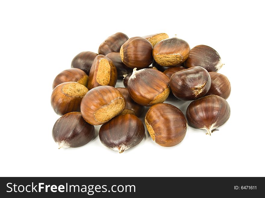 Many ripe chestnuts - isolated on white background.