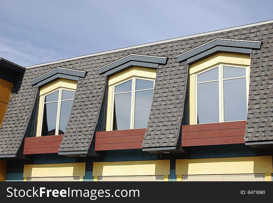 Detail of a house roof with three windows