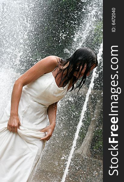Bride playing under a water fountain. Bride playing under a water fountain.