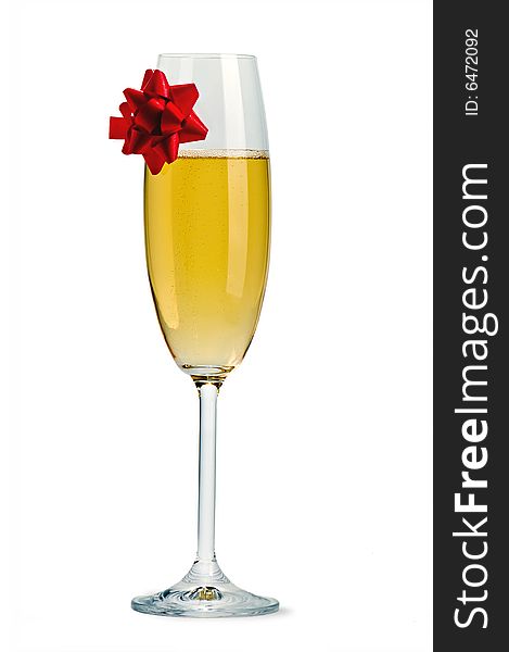 Isolated champagne flute with red ribbon bow. Isolated champagne flute with red ribbon bow