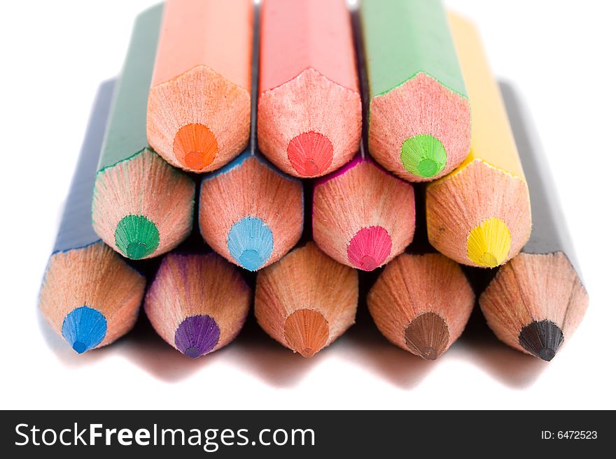 Close-up color pencils pyramid, isolated on white