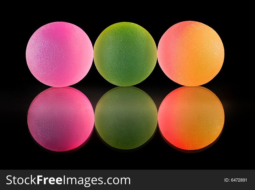 Stylish colorful balls with reflection. Isolated on black background