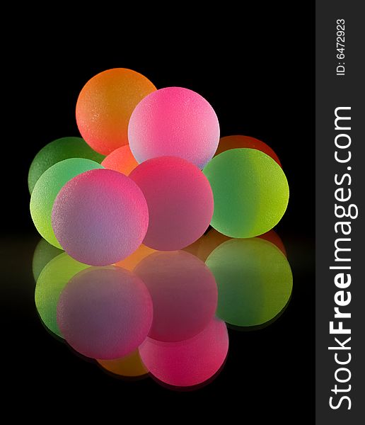 Stylish colorful balls with reflection. Isolated on black background