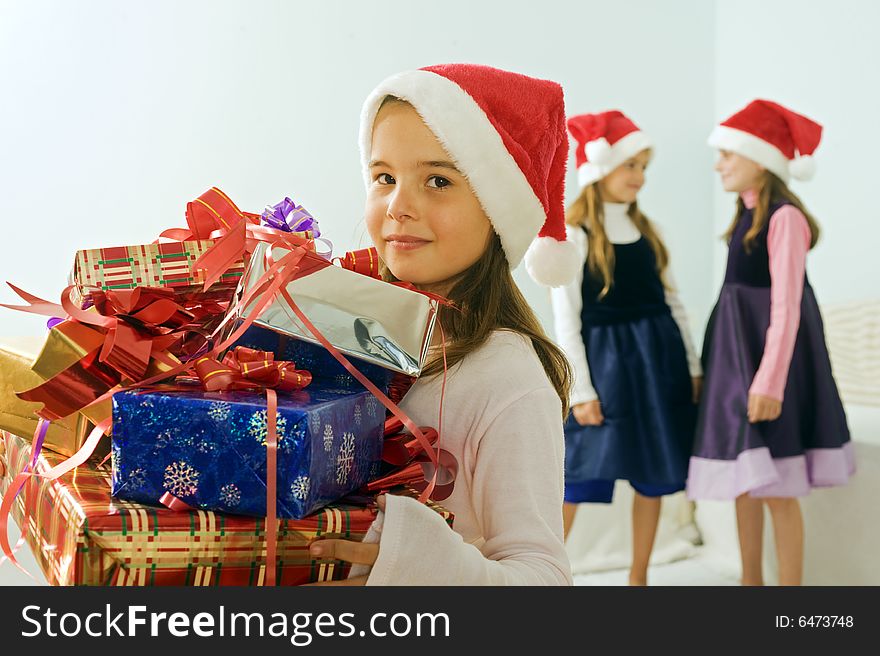 Three little girls with christmas presents