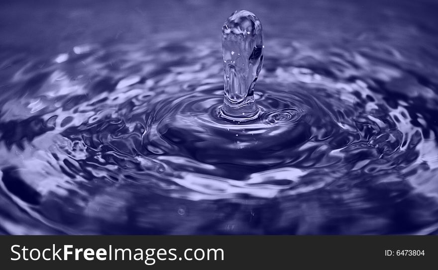 Water drop with ripples in the water