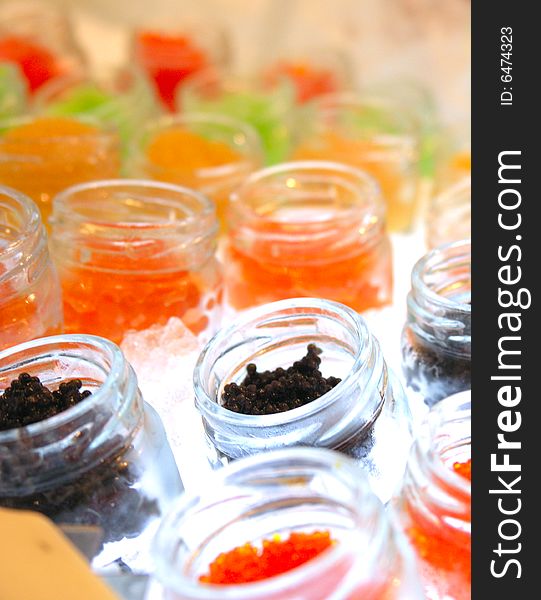 Colourful caviar delicacy inside mini bottle with ice cooler