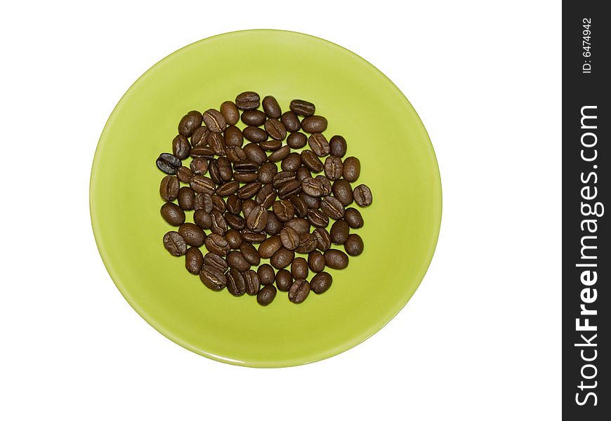 Coffee grains on a green saucer