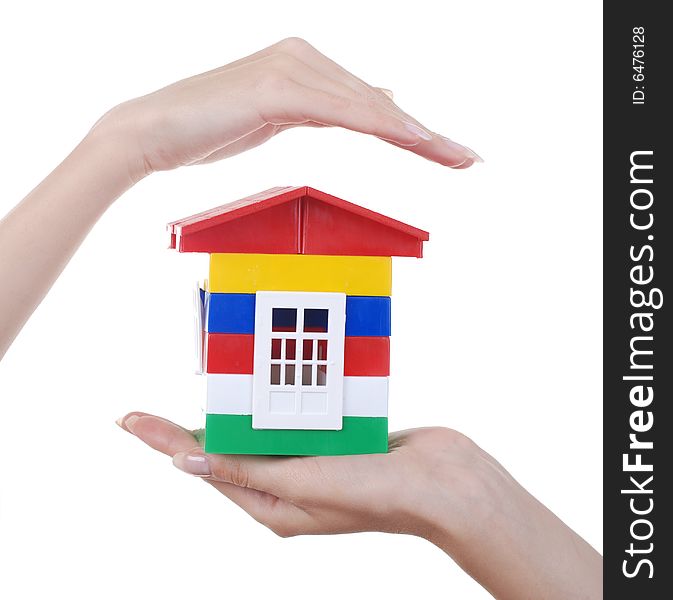 Toy colour plastic house with red roof in palms of young woman. Toy colour plastic house with red roof in palms of young woman