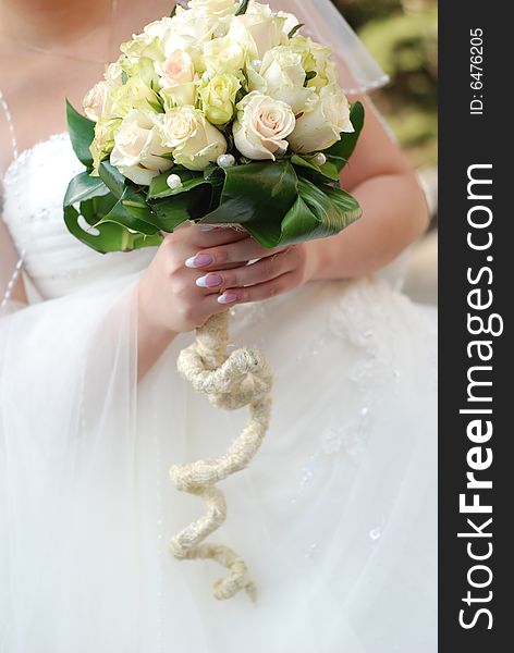 The young bride in wedding dress with bouquet. The young bride in wedding dress with bouquet