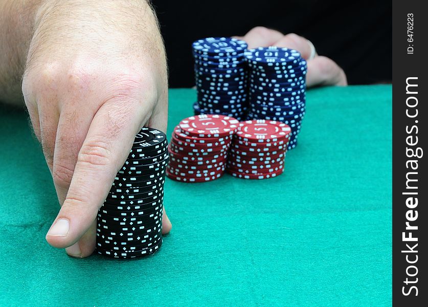 Shot of a player playing a game of poker. Shot of a player playing a game of poker