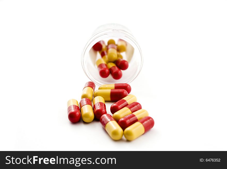 A bottle of pills on a white background