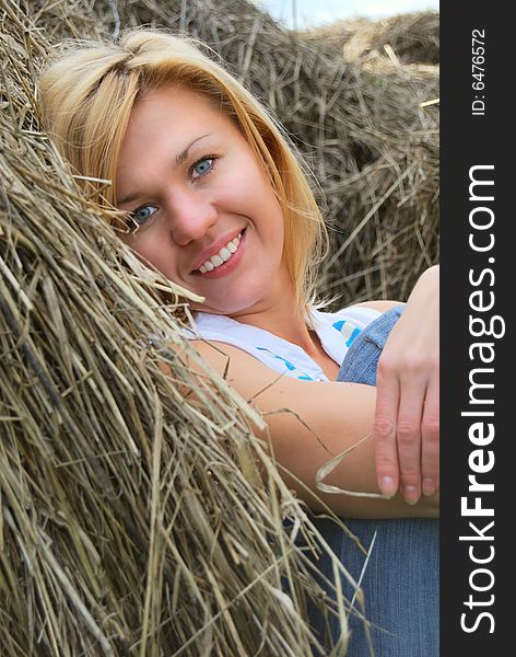 Girl in stack of hay