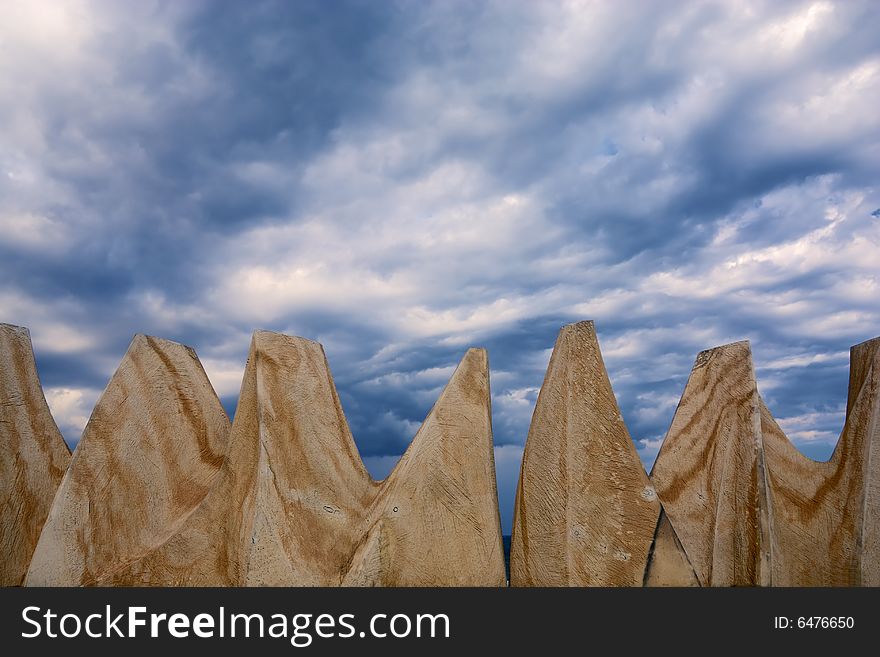 Dark stormy clouds and brown rocks. Dark stormy clouds and brown rocks