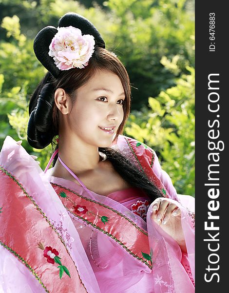 A girl in Chinese ancient dress. She wave pleasant posture. A girl in Chinese ancient dress. She wave pleasant posture..