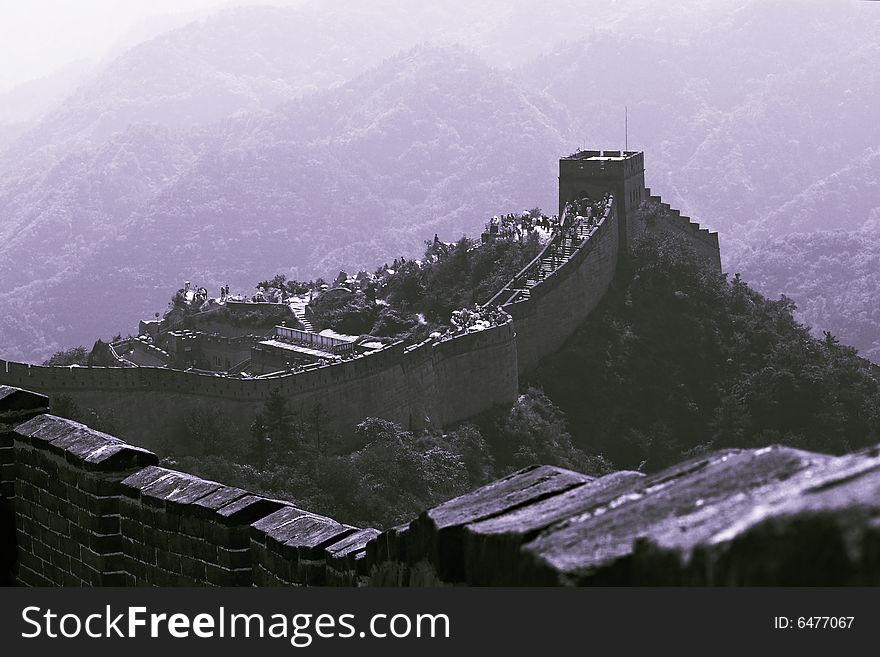 The part of Great Wall in China, wriggling among the mountains. The grand building show the agglomeration of ancient Chinese.