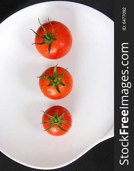 Fresh red tomatoes on white plate