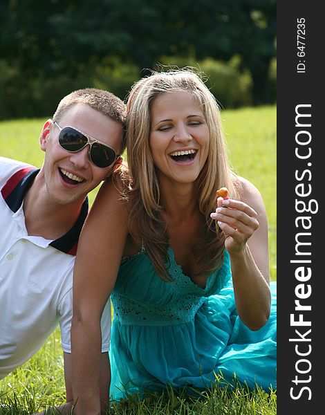 Happy young couple having fun in park