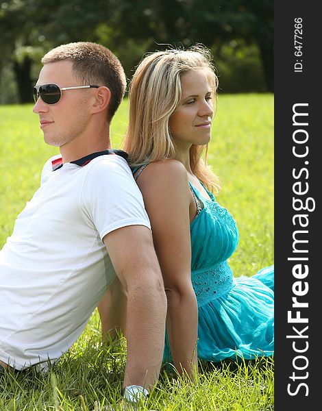 Happy young couple relaxing in park