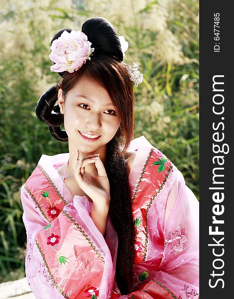 A girl in Chinese ancient dress. 
She wave pleasant posture. A girl in Chinese ancient dress. 
She wave pleasant posture..