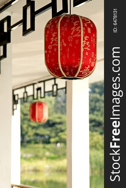 Red lantern hung in the Chinese teahouse. 

Chinese on the lantern is the ancient poesy of China, the main idea is the praise of tea culture.