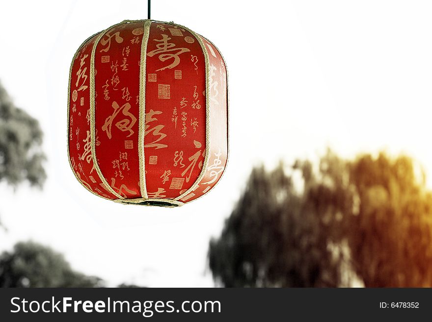 Red lantern under the setting sun.
Chinese on the lantern is the ancient poesy of China, the main idea is the praise of tea culture.