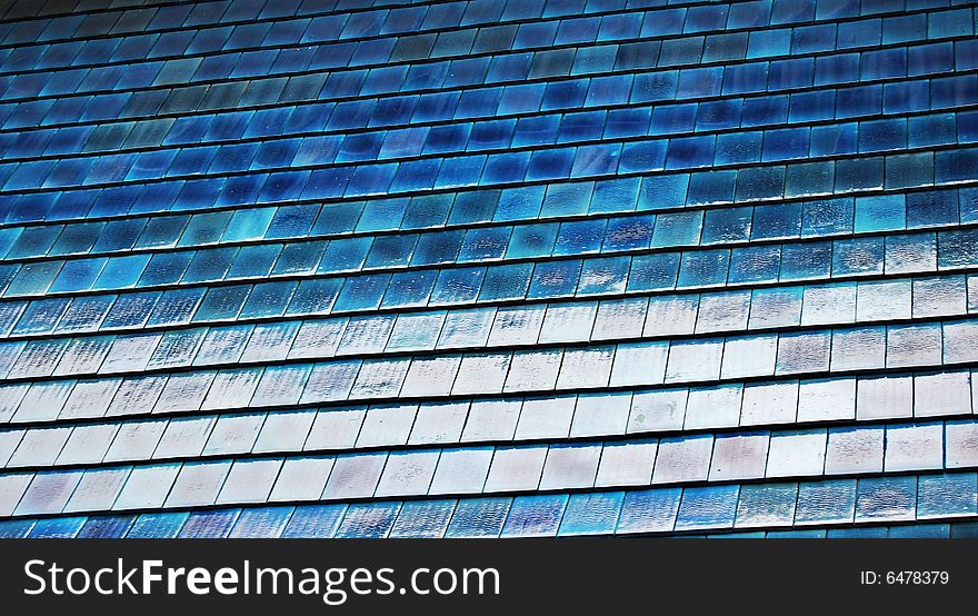 Large portion of a blue roof with shingles useful for texture or background