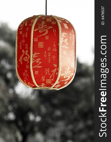 Red lantern under the setting sun. Chinese on the lantern is the ancient poesy of China, the main idea is the praise of tea culture.