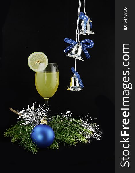 Arrangement of a cocktail with a lemon and a New Year's sphere. Arrangement of a cocktail with a lemon and a New Year's sphere