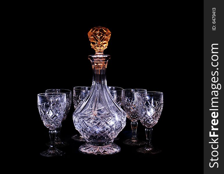 Decanter and two glasses in the black background with flash. Decanter and two glasses in the black background with flash