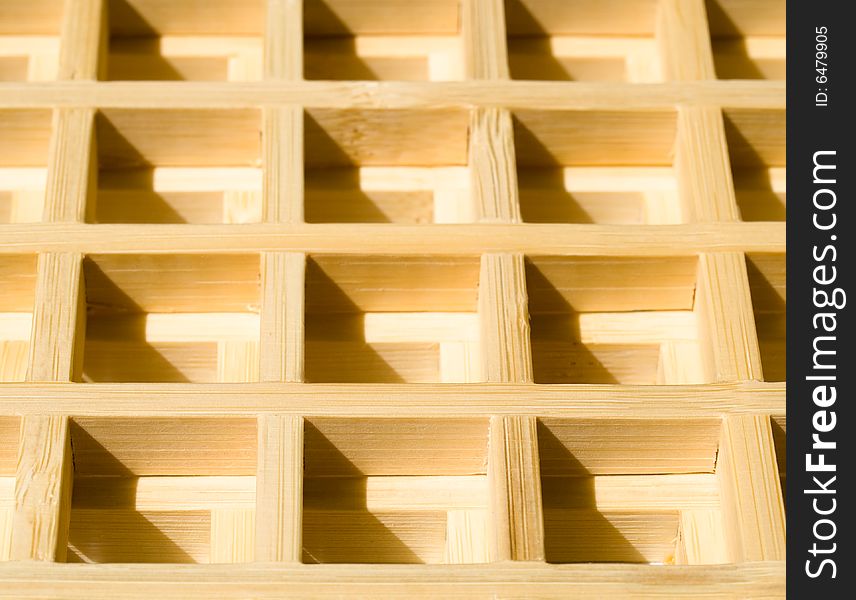 Two wooden grids overlaid on each other creating a 3D waffle pattern
