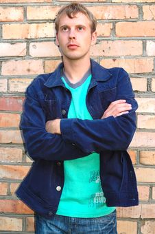 Young Stylish Man Stand Near Brick Wall. Stock Photo Young Stylish Man Stand Near Brick Wall. Stock Photo