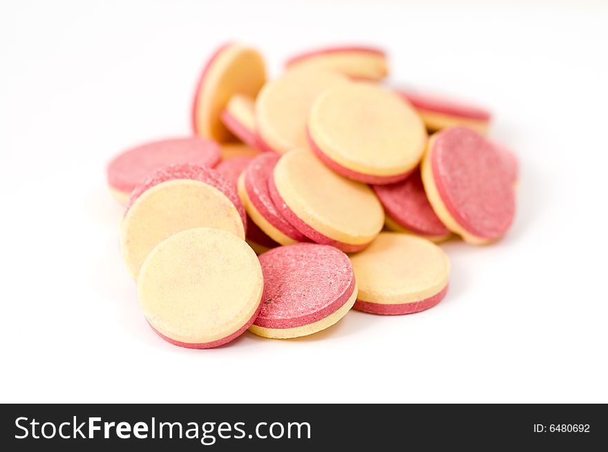 Close-up of vitamin tablets isolated on white background, shallow focus