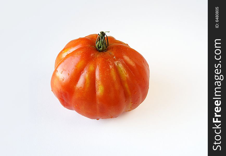 Fresh 'coeur de boeuf' (beefsteak) tomato on white background. Fresh 'coeur de boeuf' (beefsteak) tomato on white background