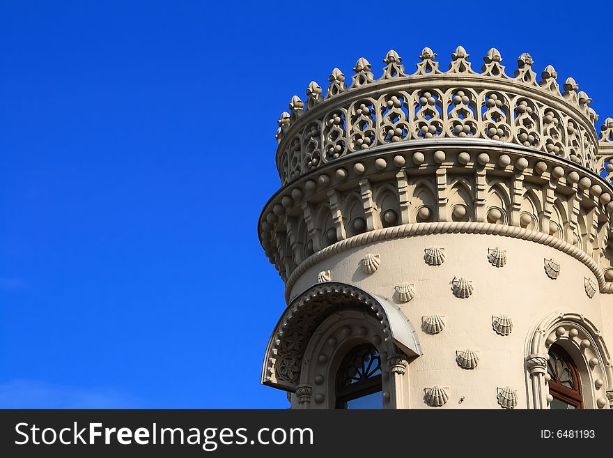 Fragment of an ancient tower decorated with patterns against the blue sky. Fragment of an ancient tower decorated with patterns against the blue sky