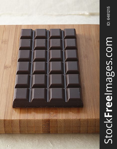 Chocolate bar on wooden board