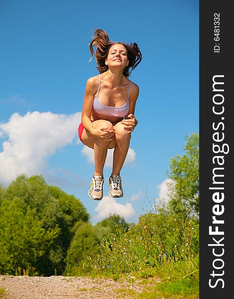 Young woman jumping, summer park