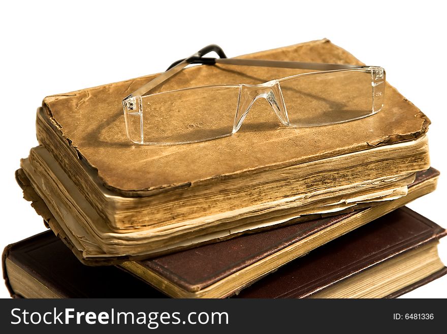 Books and spectacles on a white background